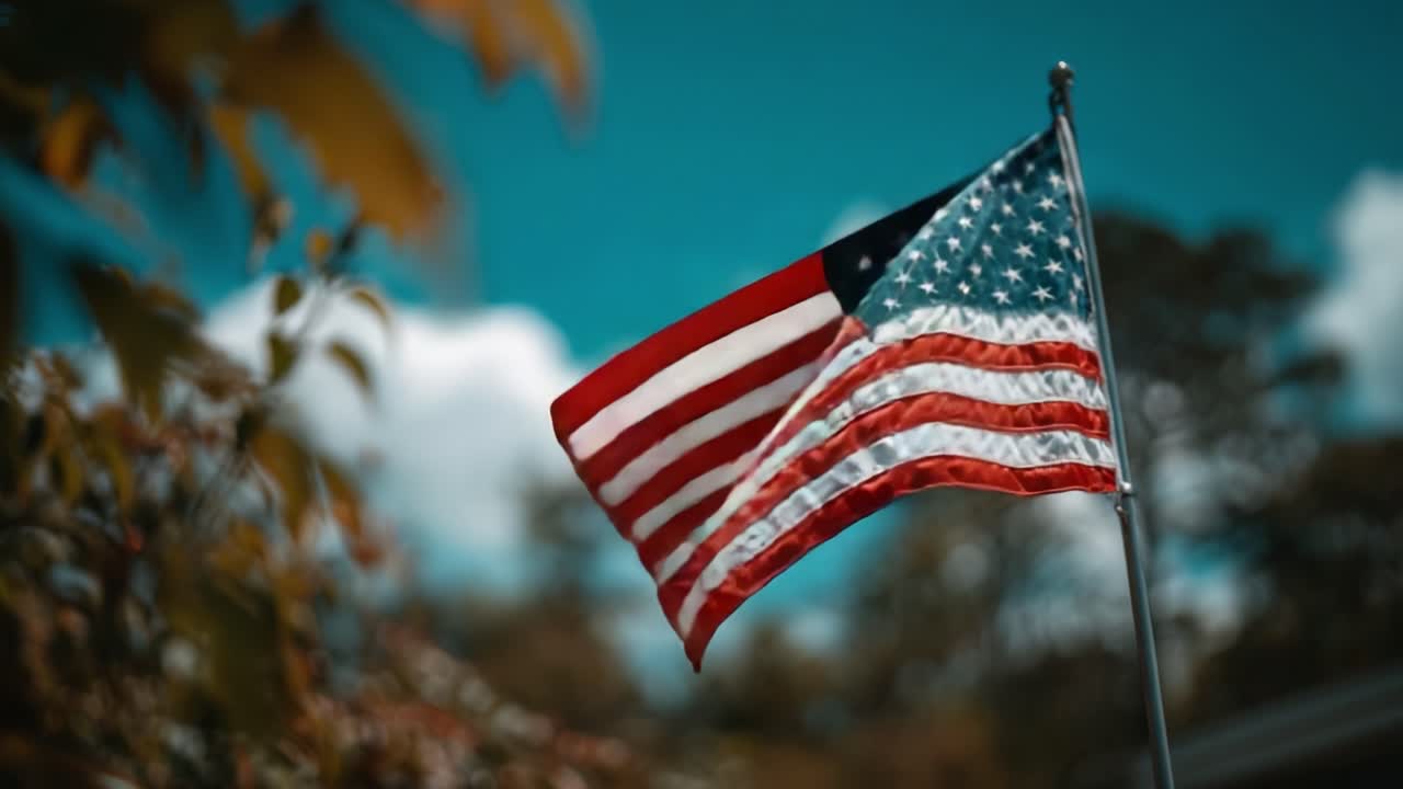 A Beautifully Waving American Flag Against a Vibrant Blue Sky Backdrop, Symbolizing Patriotism and Freedom in Nature's Splendor