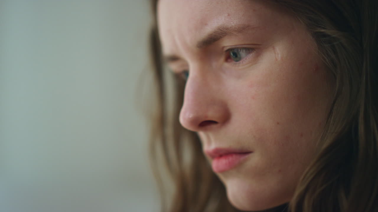 Closeup hands holding smartphone in dark room. Worried girl looking screen read