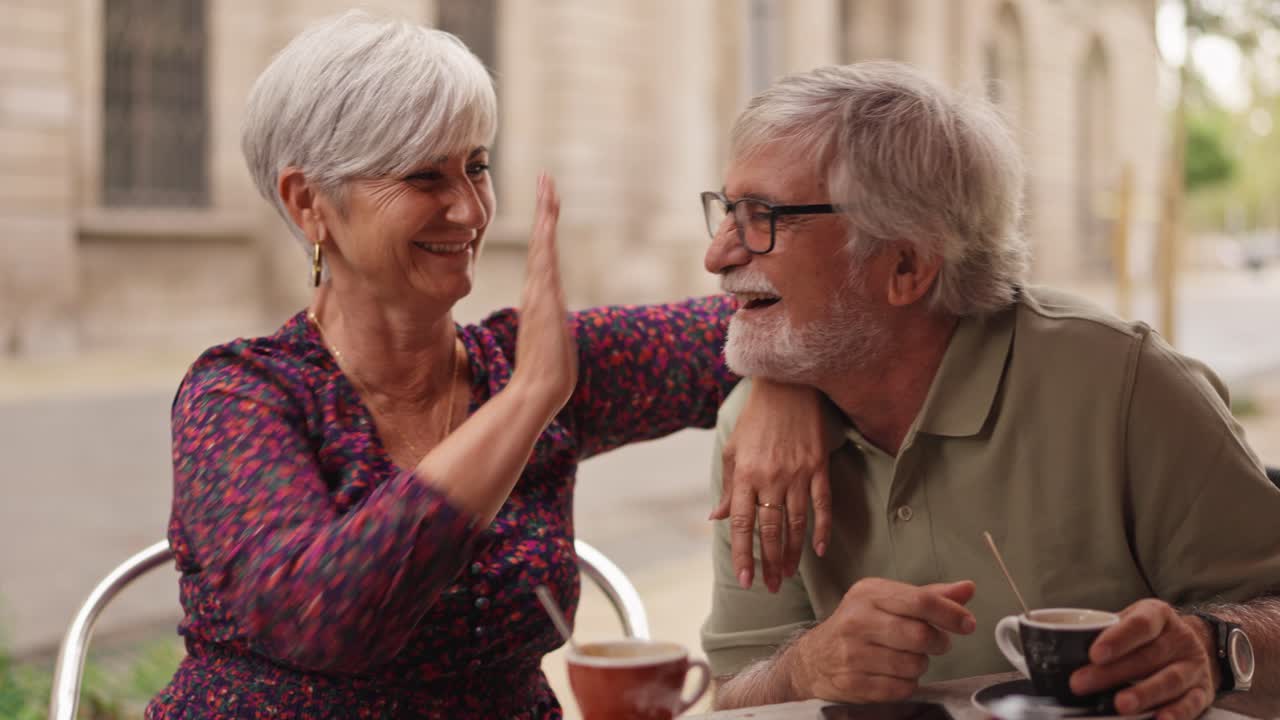 Older couple enjoying coffee at a cafe