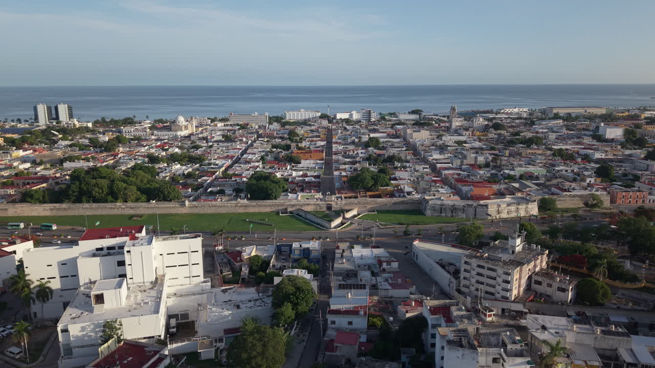Aerial drone shot flying directly above Puerta de Tierra gate and historic city walls in Campeche, Mexico