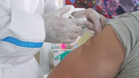 person getting covid-19 or flu vaccine at the hospital in phnom penh, cambodia - vaccination, immunization, disease prevention concept - close up