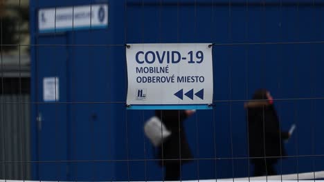 close up slow motion shot of covid 19 coronavirus vaccination test centre sign