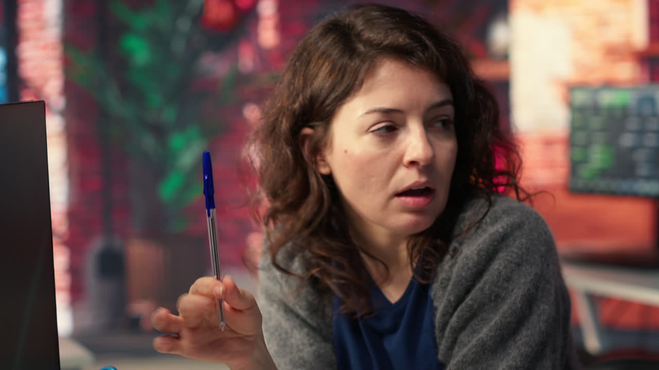 Man and woman watching business conference infographics on computer setup