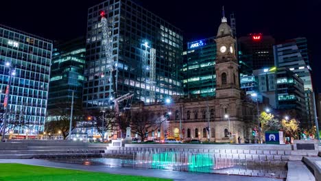 timelapse of a crane setting up at victoria square in adelaide, south australia, at night with colourful lighting and small fountains