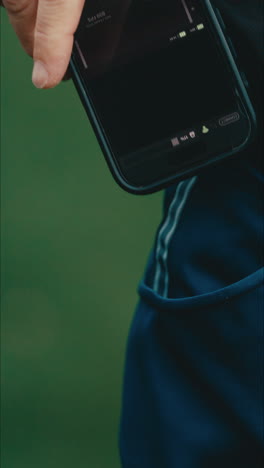 close up of man's hand grabbing his smartphone out of the pocket of his blue pants to answer a call in extreme slow motion