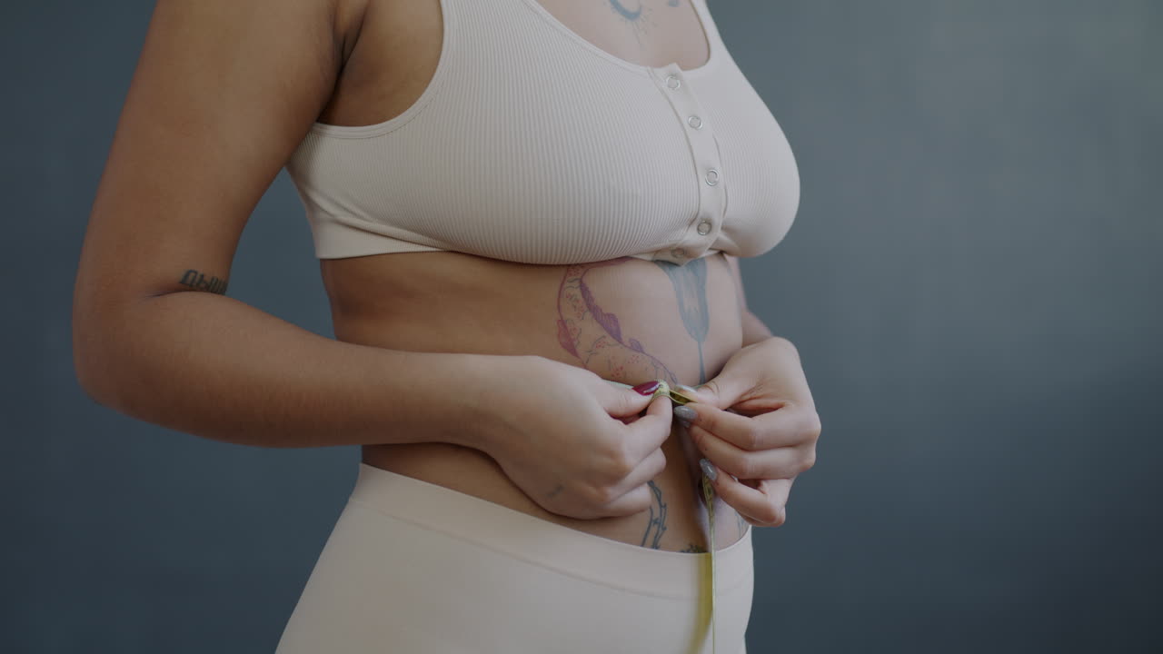 Woman Measuring Waist with Measuring Tape