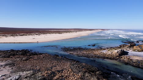 Drone-push-in-over-rocky-Atlantic-coastline-shows-birdlife-at-river-mouth