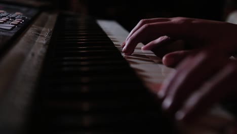 fingers playing on a keyboard