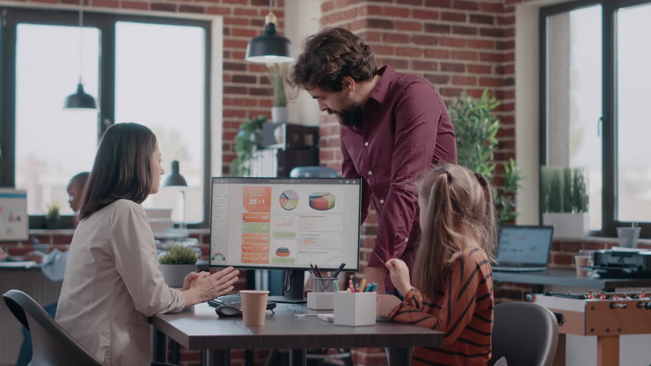 Business man drawing with child on notebook while woman working