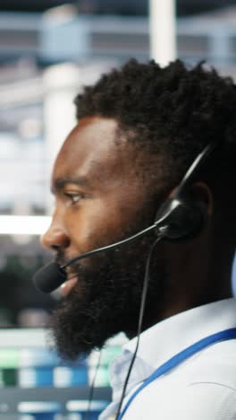 vertical video data center employee talking in headset mic, coordinating technicians