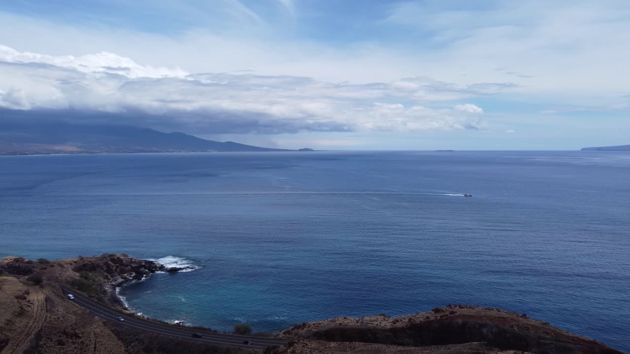 Scenic Coastal Highway with Ocean View and Dramatic Clouds in Maui, Hawaii