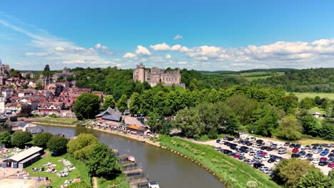 aerial drone footage of arundel, sussex england. views of the castle, river arun, paddle boarders, boats, lido, parks, cafe's and lakes can be seen. 4k