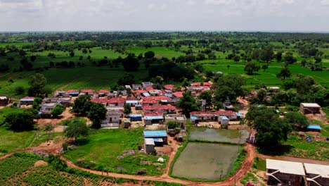rural area with cloud shadow moving on ground at tekmal village, medak district, telangana, india. day time, push in, tilt down, drone shot, 4k.
