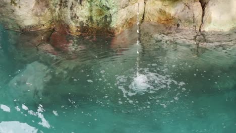 artificial waterfall in a pond with clean water