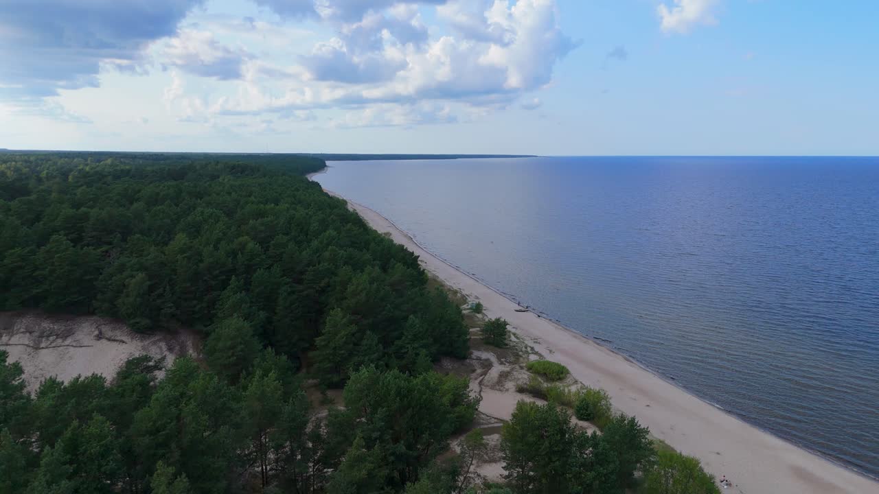 Aerial Drone Footage of Plienciems White Dune in Latvia on a Sunny Summer Day. Scenic Baltic Sea Bay Views, Peaceful Nature, and Coastal Landscape Captured in Cinematic Quality