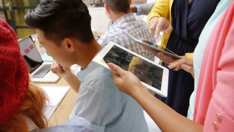 business executives using laptop and digital tablet in meeting