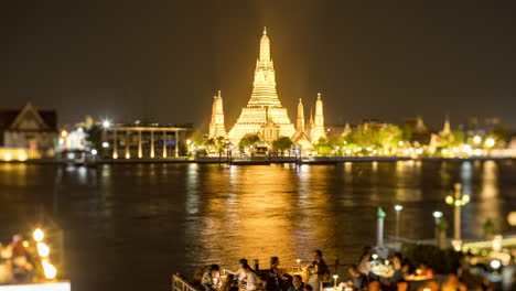 wat arun at night with riverfront dining