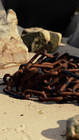 rusty chain on a sandy beach