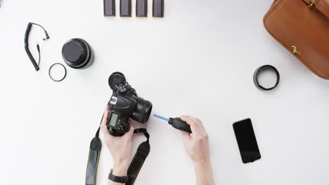 top view photographer cleaning lens working at desk from above - red epic dragon