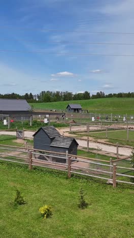 vertical view of enclosures over zoo park with rural nature background. aerial drone shot
