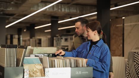 couple choosing tiles in a showroom
