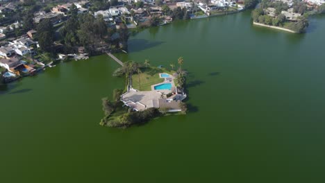 drone video of a small island club house in the middle of a lagoon or lake