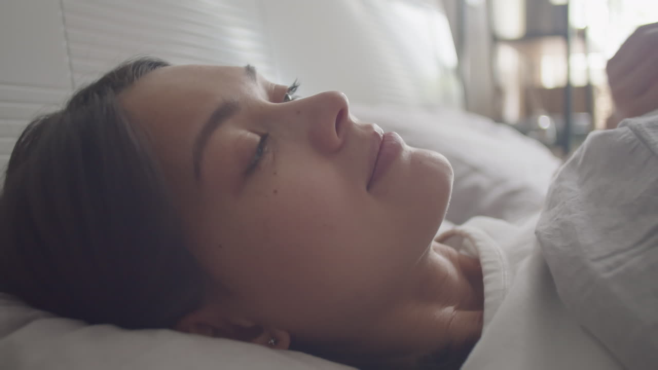 Beautiful Woman Waking Up in Bed and Posing for Camera