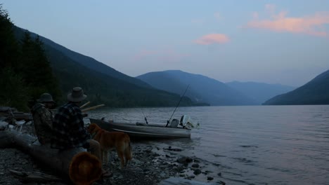 Two-fishermen-petting-dog-near-riverside-4k