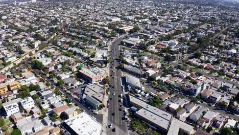 revealing aerial view of los angeles ca cityscape skyline from mid city residential neighborhood, drone shot