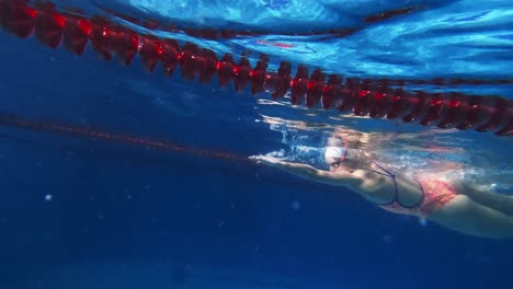 woman swimming underwater in a pool