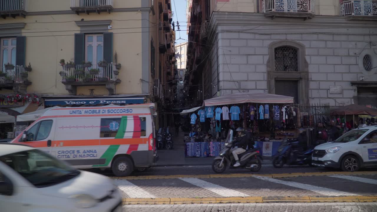 Camera shot street vendors selling football shirts in Via Toledo, Naples, Italy