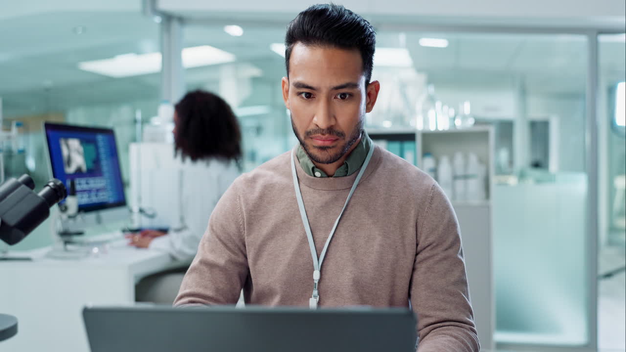 Scientist working on laptop in a laboratory