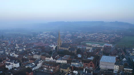 An-aerial-shot-circling-around-an-old-English-church-in-an-English-town,-Dorking,-Surrey