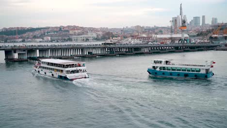 static shot of the huge passenger ferry passing under the bridge in istanbul