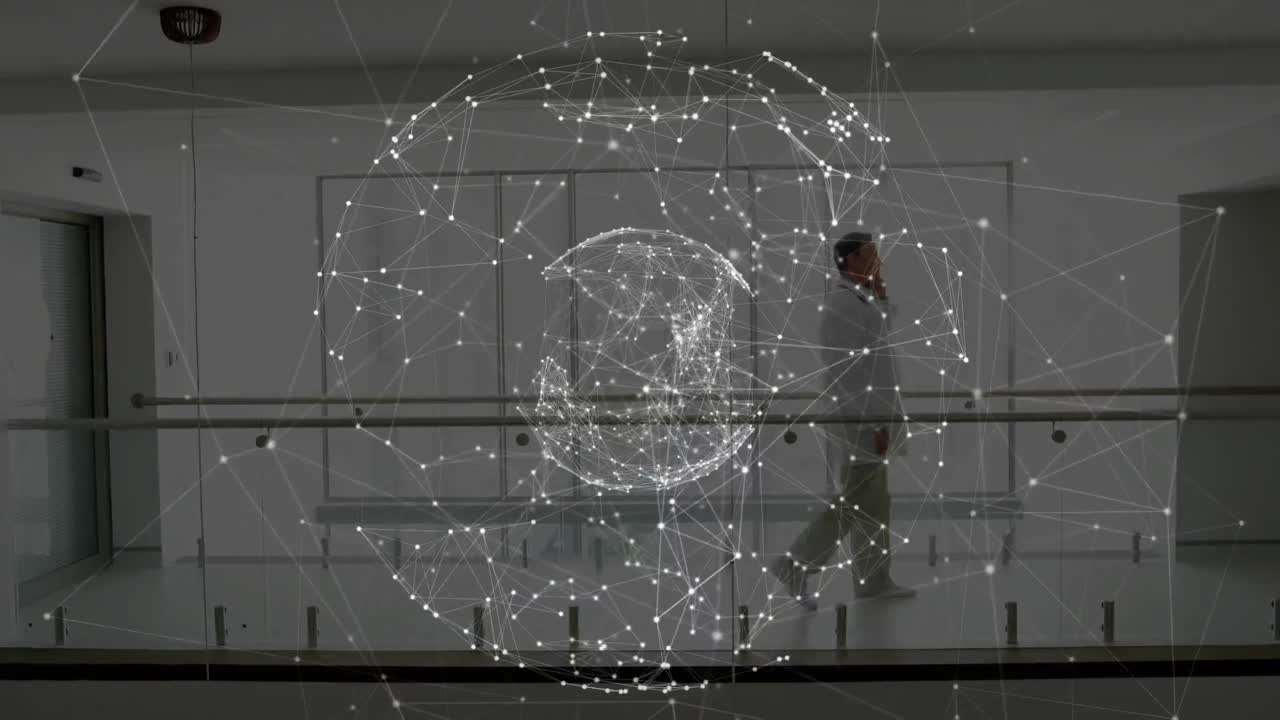 Globe of network of connections spinning against male doctor talking on smartphone at hospital