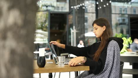 young woman working in an outdoor cafe