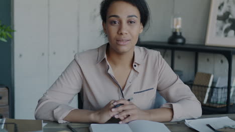 woman taking notes during a virtual meeting or class
