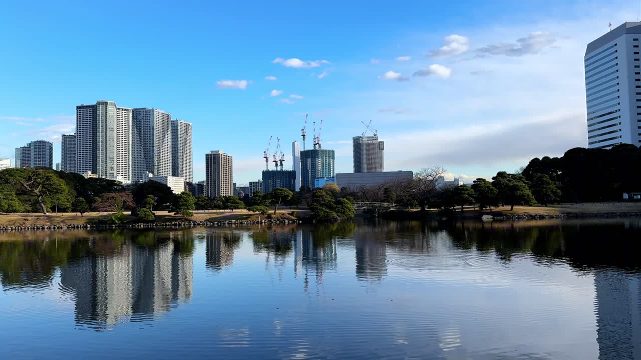 A serene reflection of skyscrapers and nature in Hama Rikyu Gardens, Tokyo