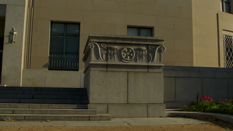 an entrance of the federal trade commission panning to the man controlling trade statue in spring in washington