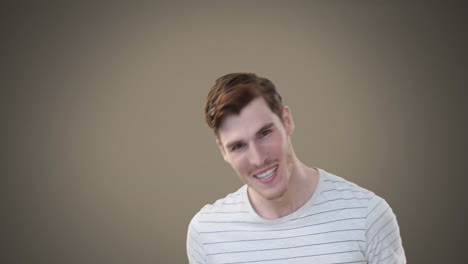 caucasian man wearing a stripped t-shirt laughing and looking at camera