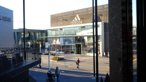 shopping center with adidas and kors stores