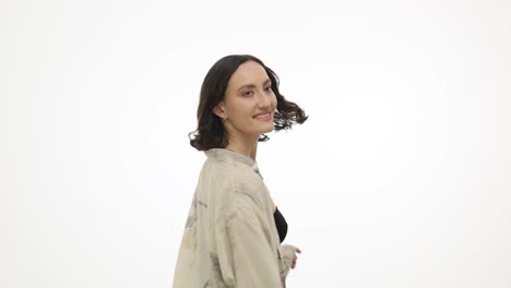 a happy woman smiling and posing in a studio