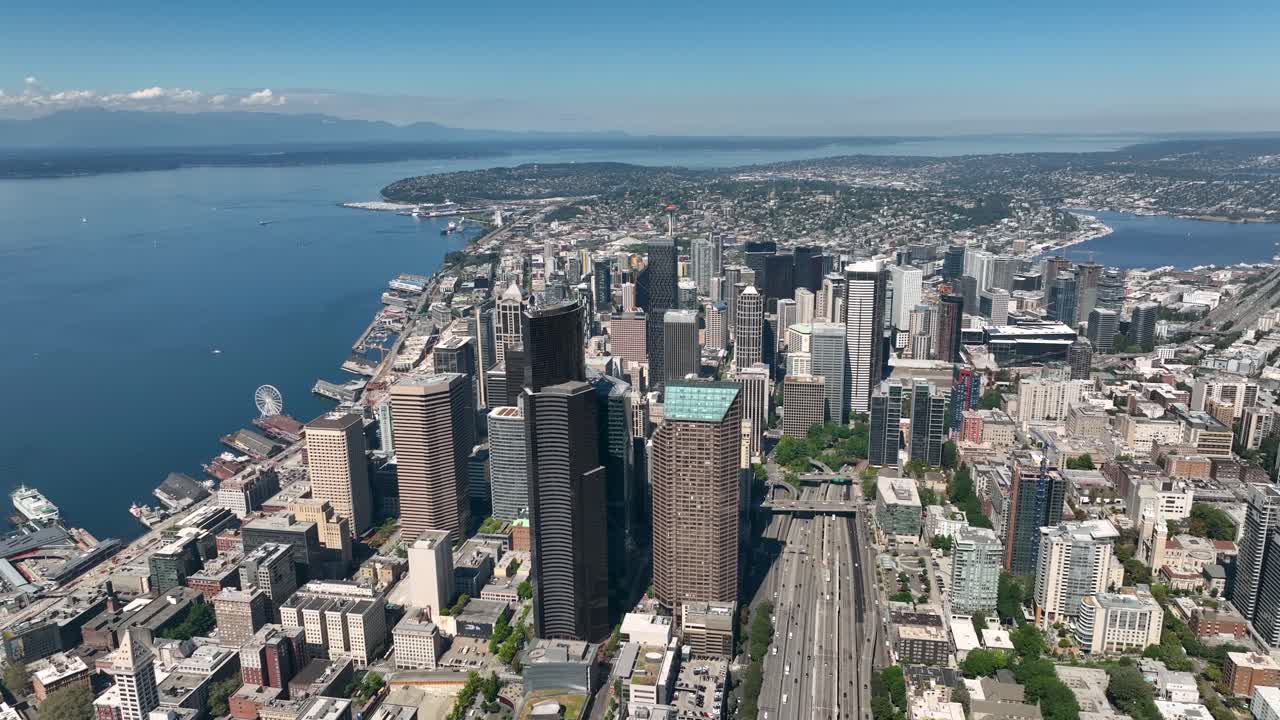 Wide drone shot of Seattle's downtown sector with numerous skyscrapers standing tall