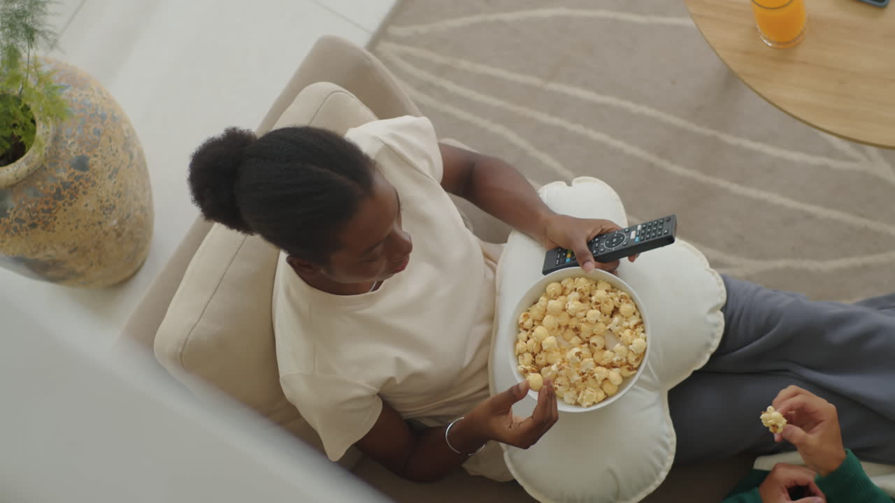 Woman Eating Popcorn, Relaxing on Couch with Boyfriend, Watching TV