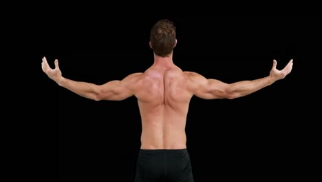 rear view  of muscular man outstretching his arms