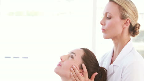 physiotherapist doing head massage to her patient