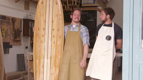 carpenter and apprentice with surfboard shot on red camera