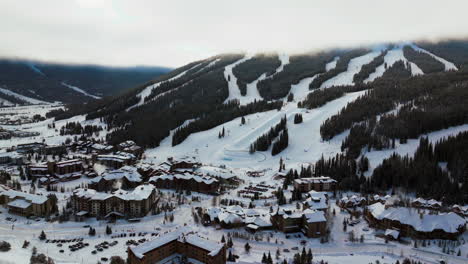 copper mountain colorado ski resort foggy cloud layer winter snowy early morning sunrise aerial drone i70 eagle flyer lift center village half pipe ikon pass snowboard backward slowly pan up backwards