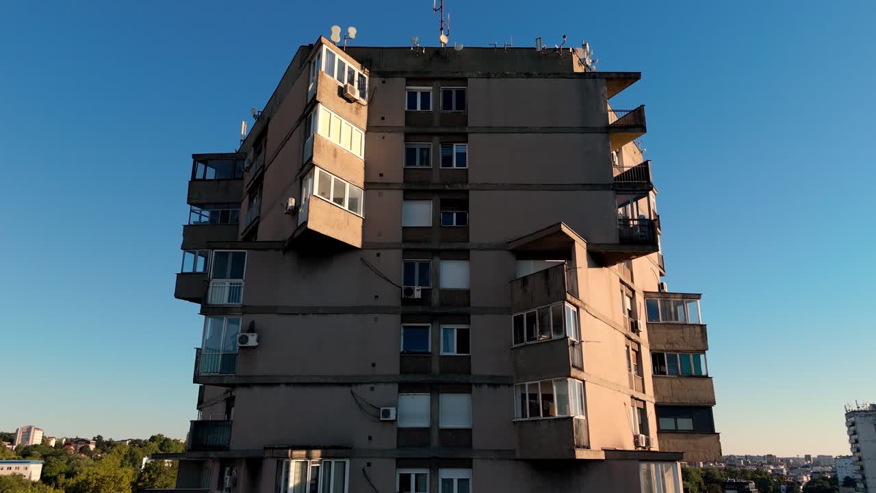 Aerial drone shot of Karaburma Housing Tower in Belgrade, Serbia a striking brutalist structure with geometric concrete forms under clear blue sky, symbol of urban minimalism