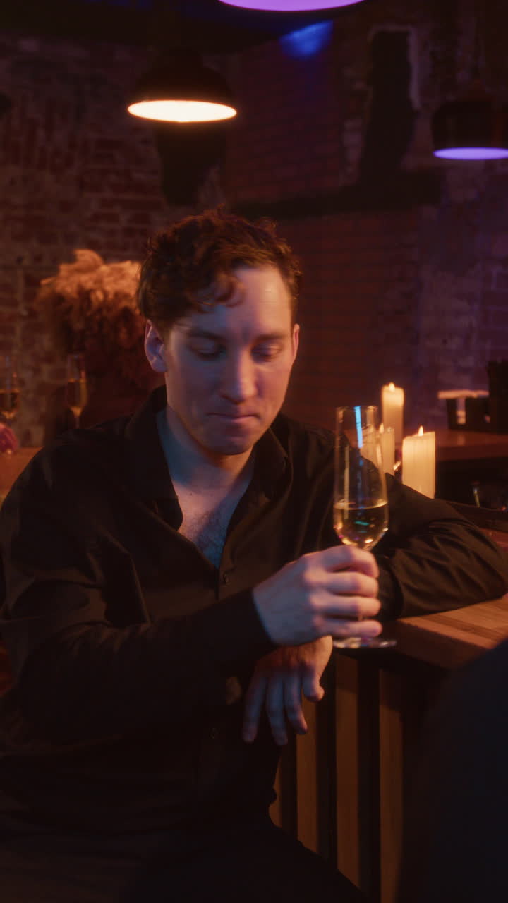 People at a bar drinking wine